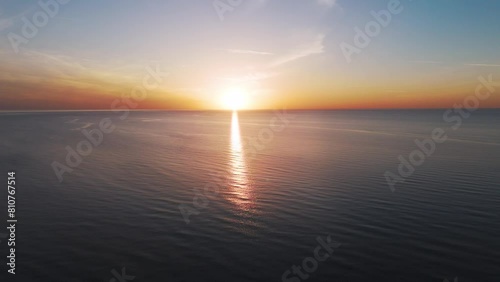 Aerial View of the Baltic Sea at Sunset, Jurkalne, Latvia. Beautiful Golden Sunset Over the Beach Seascape. Glittering Sunlight Reflection. The Baltic Sea at the Jurkalne Seashore Bluffs photo