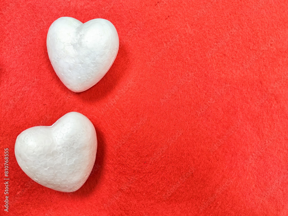 White foam hearts on a red background. The texture. valentine's day. Two White Foam Hearts on a Textured Red Background for Valentines Day White foam hearts on a red background. The texture. valentine's day. Two White Foam Hearts on a Textured Red Background for Valentines Day