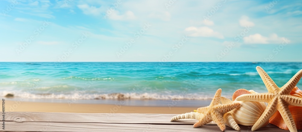 A serene summer sea backdrop adorned with starfish shells and a wooden surface provides an ideal copy space image A serene summer sea backdrop adorned with starfish shells and a wooden surface provides an ideal copy space image