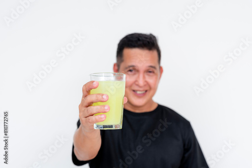 Middle aged Asian man enjoying a cold glass of lemonade isolated on white