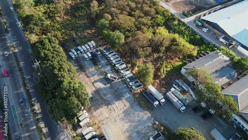 Trucks Parked On Roadside Near Development Site In Las Piñas, Metro Manila, Philippines. aerial shot photo