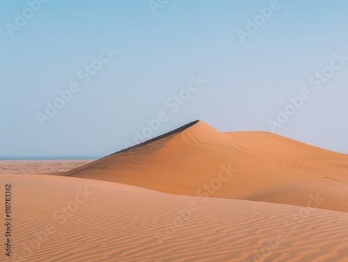 Vast desert sand dunes under blue sky