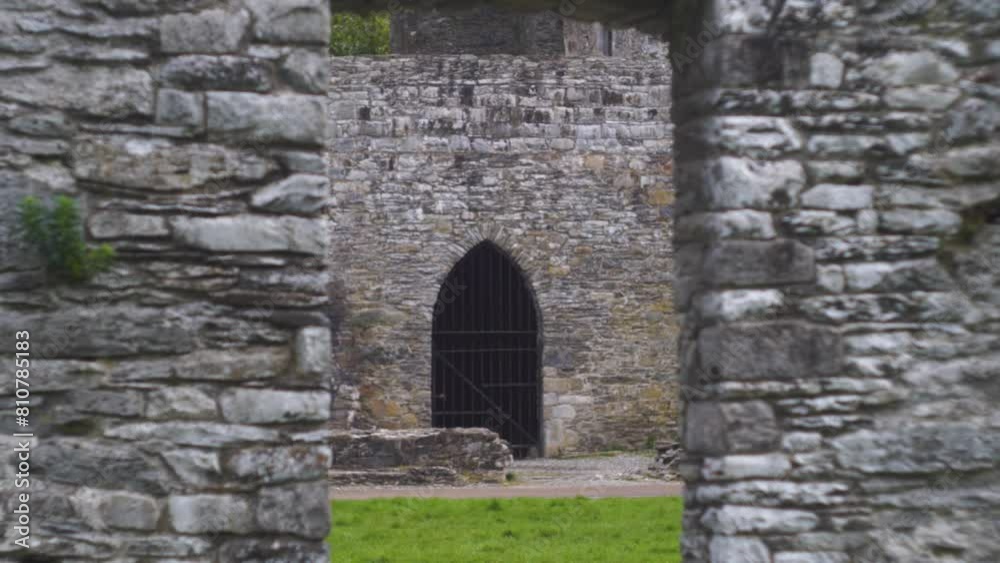 Stone walls frame a black gate at Old Mellifont Abbey, Ireland, captured with a vintage Helios lens Stone walls frame a black gate at Old Mellifont Abbey, Ireland, captured with a vintage Helios lens