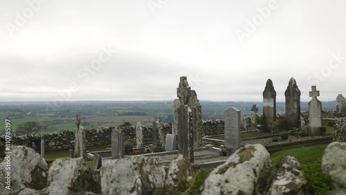 Ancient cemetery with medieval tombstones at the Hill of Slane, overlooking lush Irish landscape photo