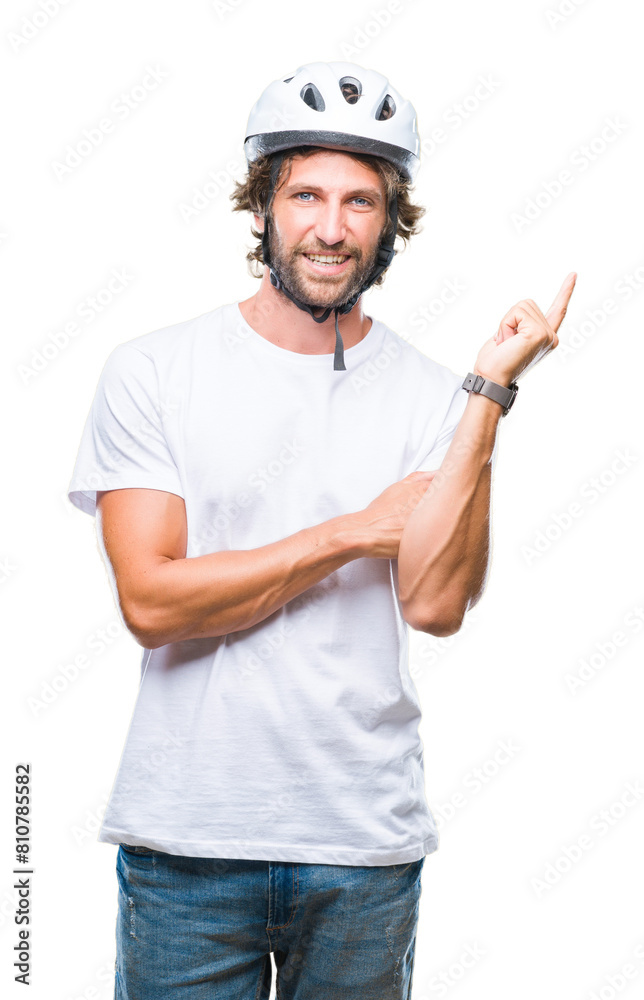 Handsome hispanic cyclist man wearing safety helmet over isolated background with a big smile on face, pointing with hand and finger to the side looking at the camera. Handsome hispanic cyclist man wearing safety helmet over isolated background with a big smile on face, pointing with hand and finger to the side looking at the camera.