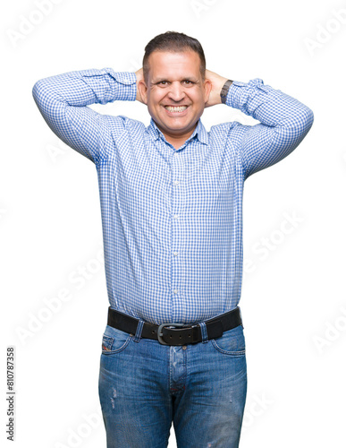 Middle age arab business man over isolated background Relaxing and stretching with arms and hands behind head and neck, smiling happy