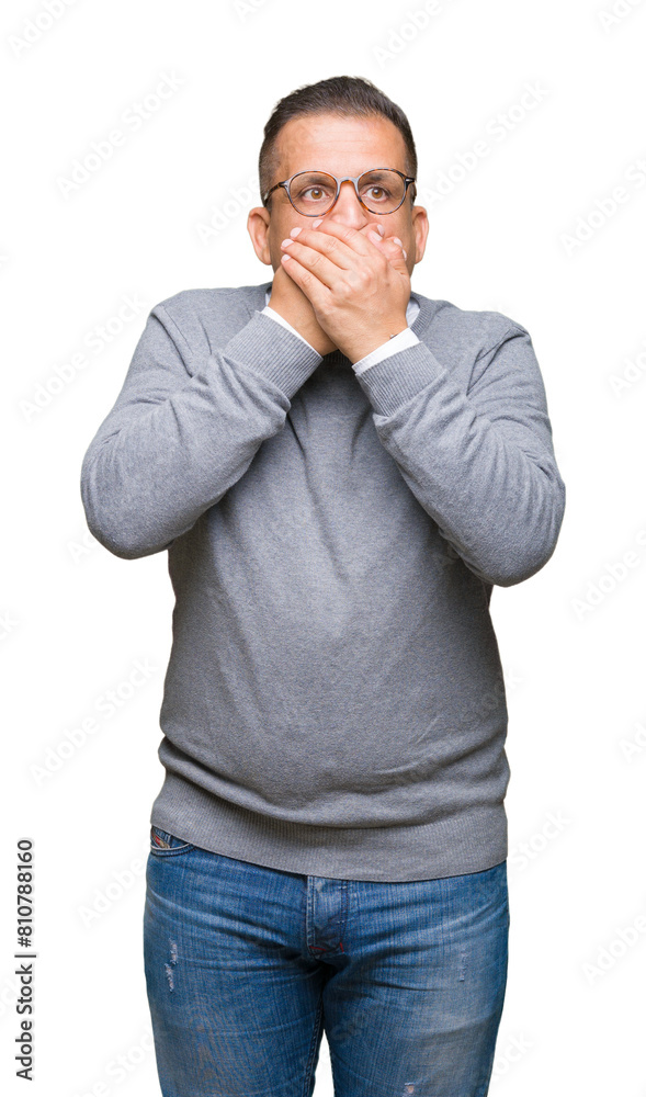 Middle age bussines arab man wearing glasses over isolated background shocked covering mouth with hands for mistake. Secret concept. Middle age bussines arab man wearing glasses over isolated background shocked covering mouth with hands for mistake. Secret concept.