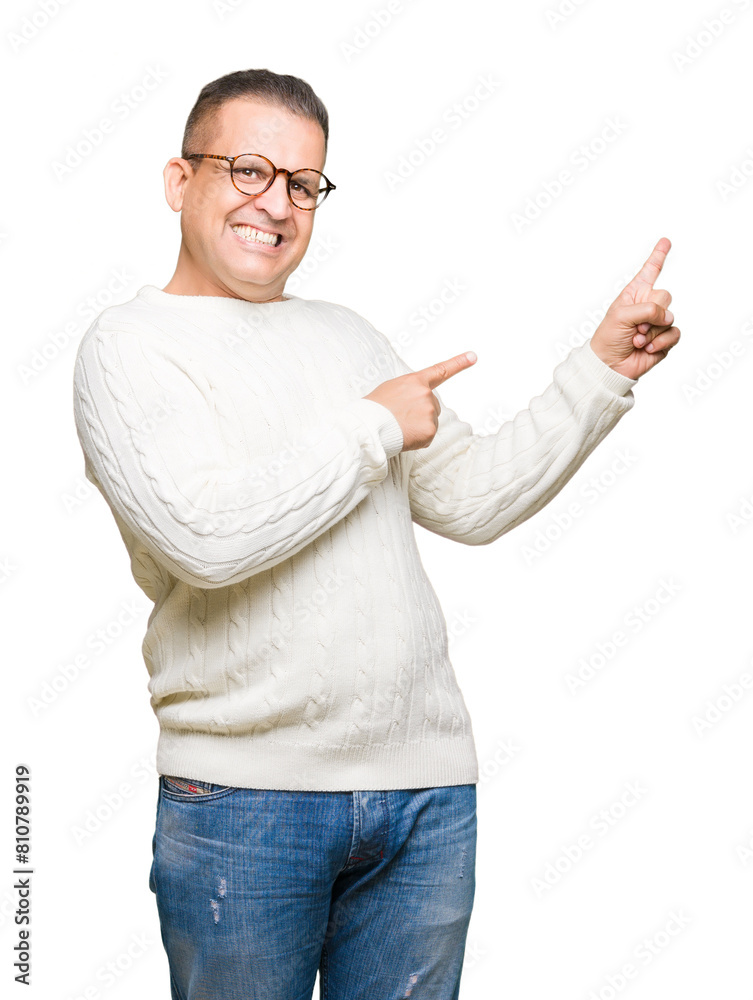 Middle age arab man wearing glasses over isolated background smiling and looking at the camera pointing with two hands and fingers to the side.