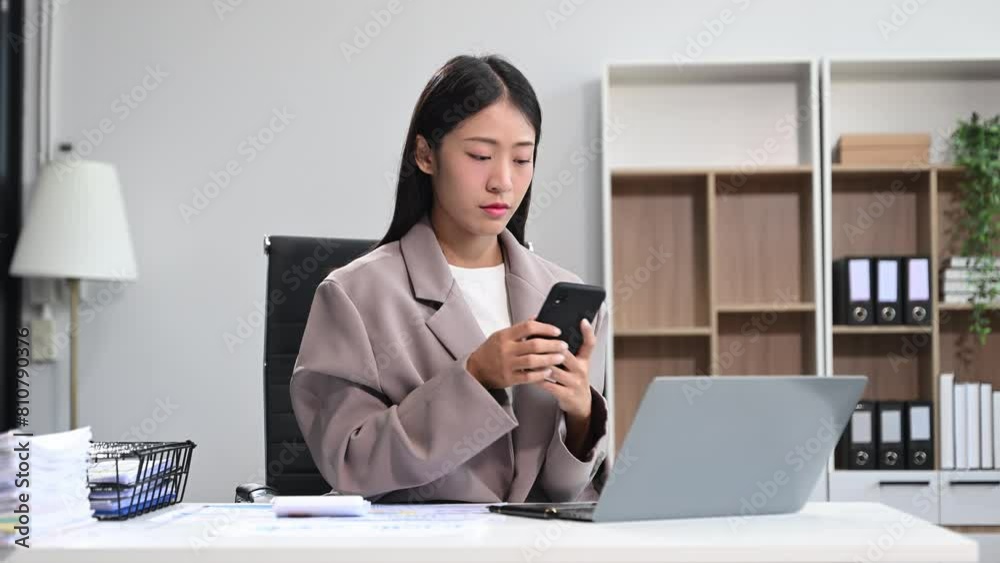 Asian business woman is stressed, bored, and overthinking from working on a tablet Asian business woman is stressed, bored, and overthinking from working on a tablet