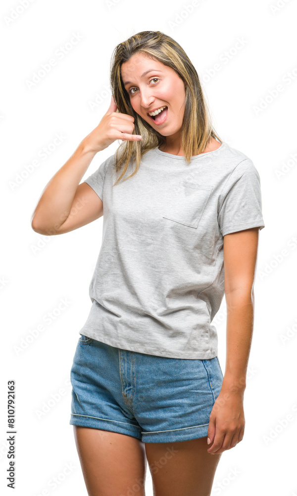 Young beautiful woman over isolated background smiling doing phone gesture with hand and fingers like talking on the telephone. Communicating concepts. Young beautiful woman over isolated background smiling doing phone gesture with hand and fingers like talking on the telephone. Communicating concepts.