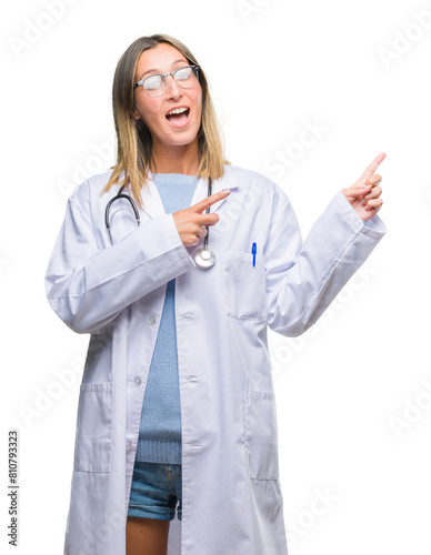 Young beautiful doctor woman headphones over isolated background smiling and looking at the camera pointing with two hands and fingers to the side.