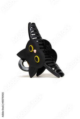 Close-up shot of a black hair clip. Hair claw clip shaped like a cat's head is on a white background. Side view. A fashionable hair accessory.
