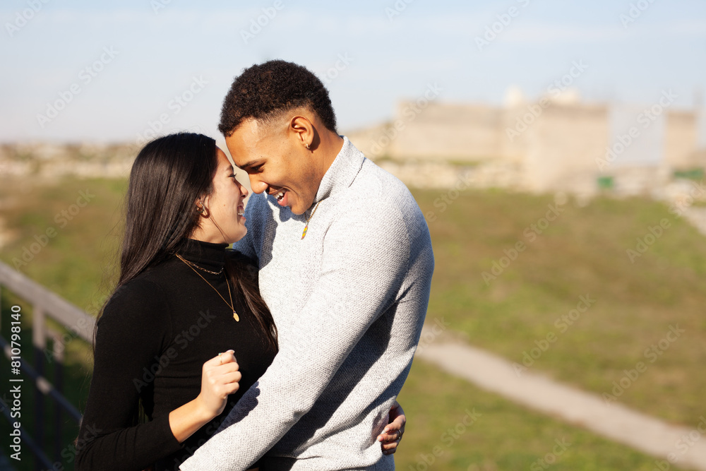 Multiracial couple posing in a fortress. Man and woman in love. Multiracial couple posing in a fortress. Man and woman in love.