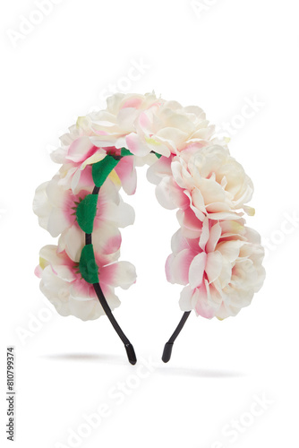  
 	 
 
Close-up shot of a handmade plastic hairband decorated with light pink roses. The bright floral wreath for head is isolated on a white background. Side view.