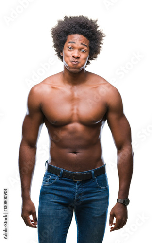 Afro american shirtless man showing nude body over isolated background puffing cheeks with funny face. Mouth inflated with air, crazy expression.