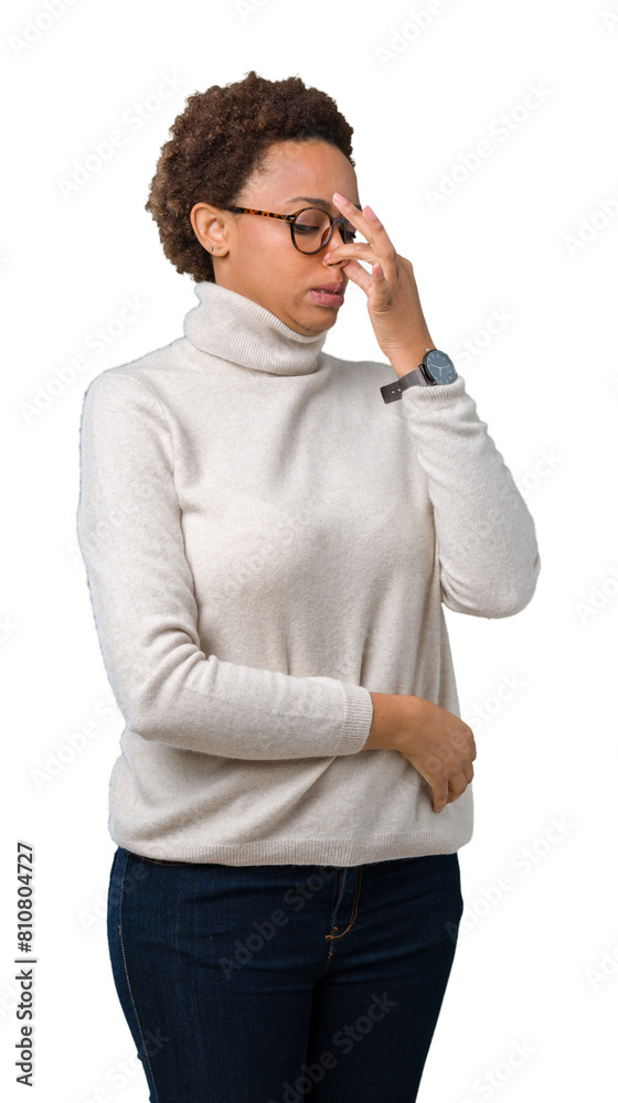 Young beautiful african american woman wearing glasses over isolated background smelling something stinky and disgusting, intolerable smell, holding breath with fingers on nose. Bad smells concept. Young beautiful african american woman wearing glasses over isolated background smelling something stinky and disgusting, intolerable smell, holding breath with fingers on nose. Bad smells concept.