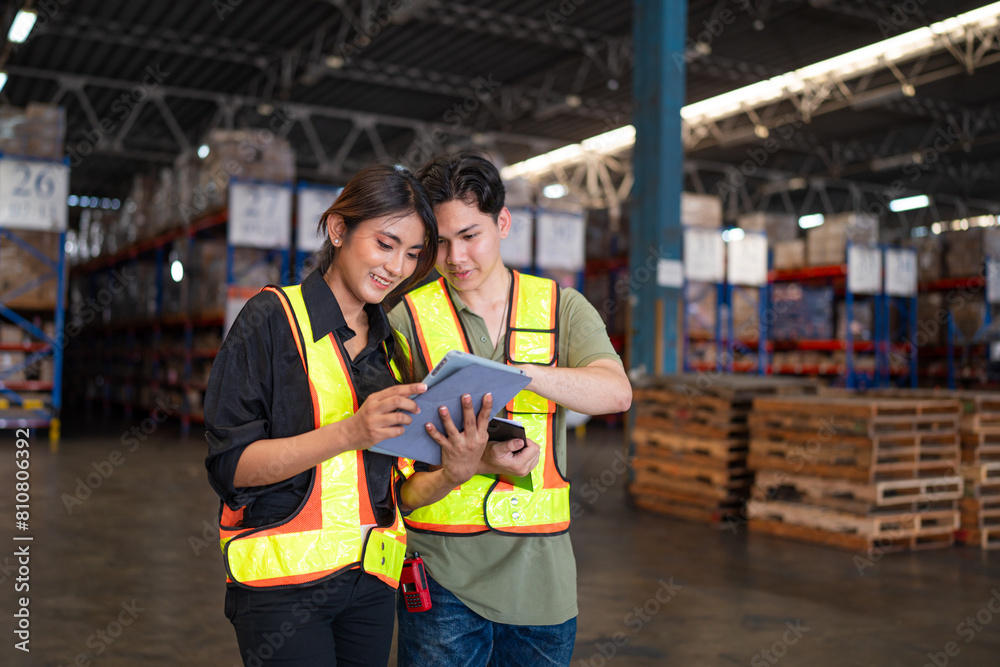 Warehouse manager talking and using digital tablet while checking product in warehouse, Logistic industry concept. Warehouse manager talking and using digital tablet while checking product in warehouse, Logistic industry concept.