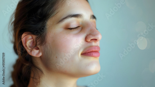Woman with her eyes closed, enjoying the daylight, calm atmosphere photo