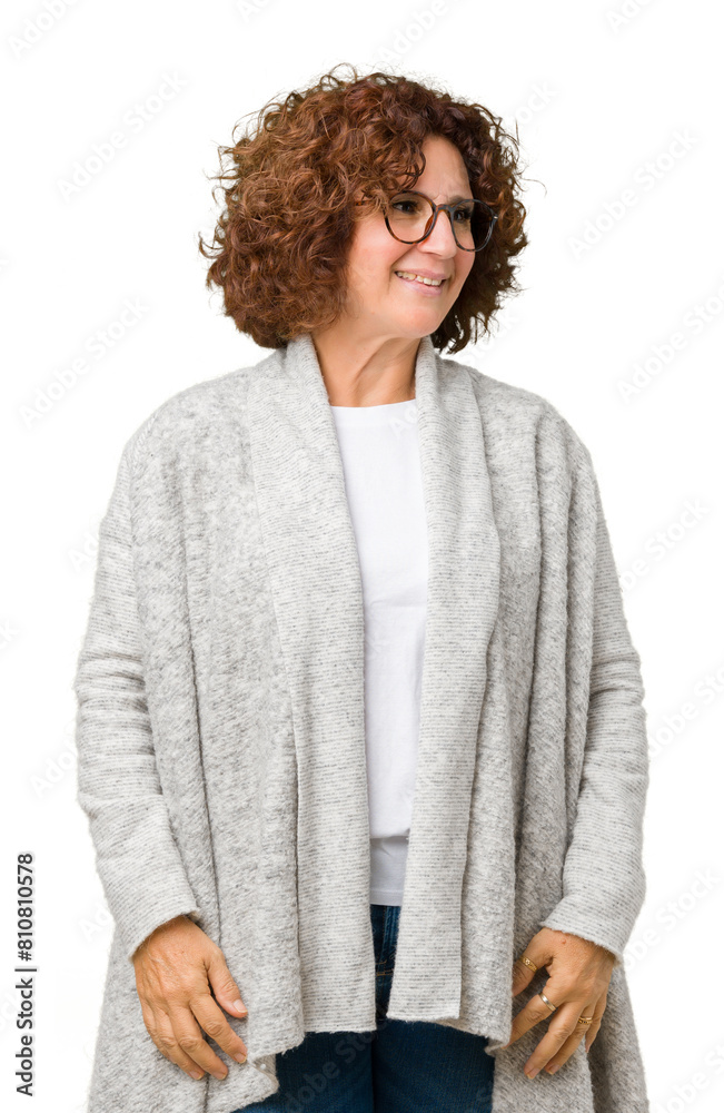 Beautiful middle ager senior woman wearing jacket and glasses over isolated background looking away to side with smile on face, natural expression. Laughing confident. Beautiful middle ager senior woman wearing jacket and glasses over isolated background looking away to side with smile on face, natural expression. Laughing confident.