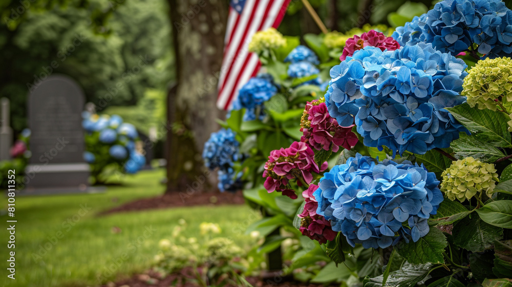 Memorial Day flag and hydrangeas paint a somber scene on an overcast day at a grave.