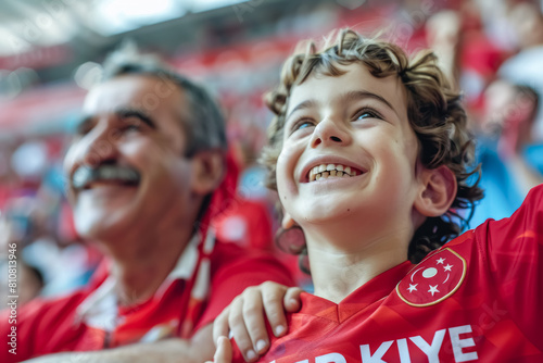 Turkish football soccer fans in a stadium supporting the national team, father and son, Ay-Yildizlilar 