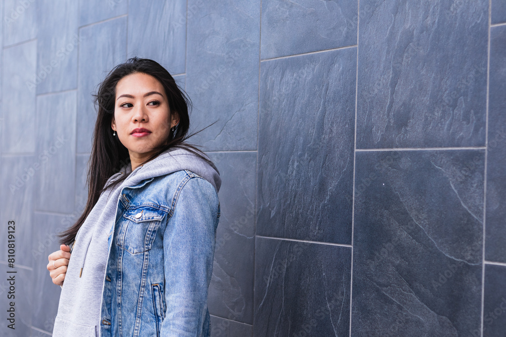 Obraz premium Young Asian woman in city serious face portrait
