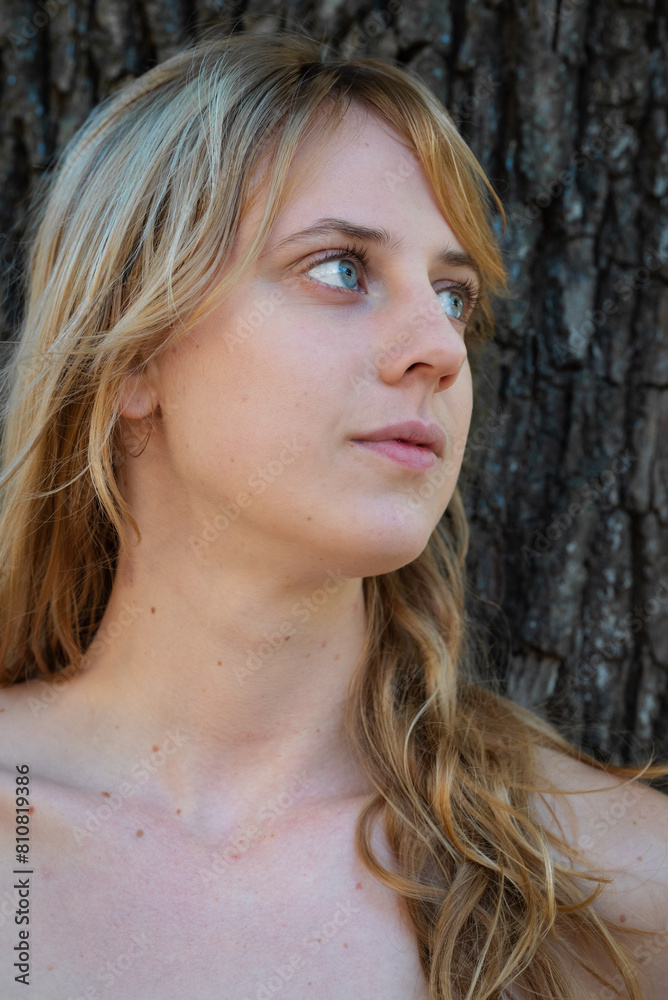 Closeup of a blonde girl posing in a park or natural area. Closeup of a blonde girl posing in a park or natural area.