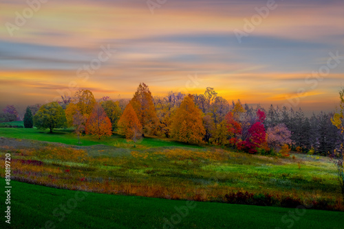 Sunset with bright, saturated sky over farms,