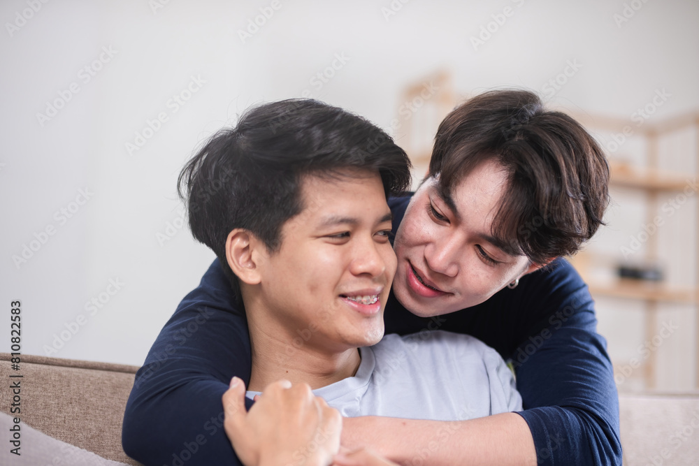 A male-male couple spends their free time happily doing holiday activities together, embracing each other and taking selfies together in the living room. A male-male couple spends their free time happily doing holiday activities together, embracing each other and taking selfies together in the living room.