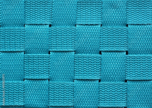 Turquoise square structured pattern cloth. The background of knitted artificial cloth material.