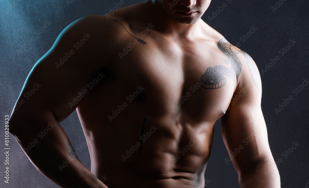 Fototapeta premium Man, body and fitness abs in studio for wellness or bodybuilder, strong and dark for power or strength. Person, six pack and stomach with muscle, isolated and black background for aesthetic shadow.