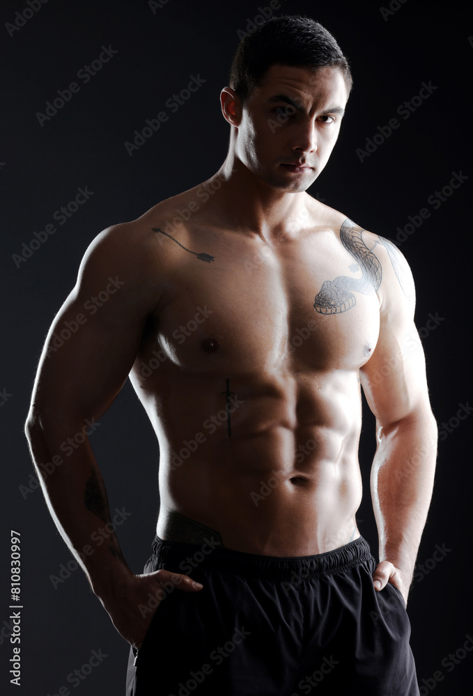 Fototapeta premium Man, sixpack or strong muscle for fitness goals, workout or training portrait health wellness. Bodybuilder, sports athlete and male model body on aesthetic backdrop on black studio background