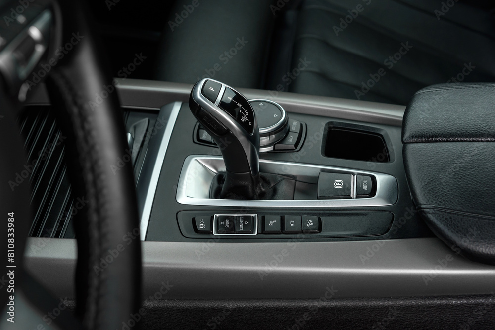 Gear lever for automatic transmission. Transmission control dial. Premium luxury SUV elements. Car air conditioning and climate control. Black interior of a modern business class car. Gear lever for automatic transmission. Transmission control dial. Premium luxury SUV elements. Car air conditioning and climate control. Black interior of a modern business class car.