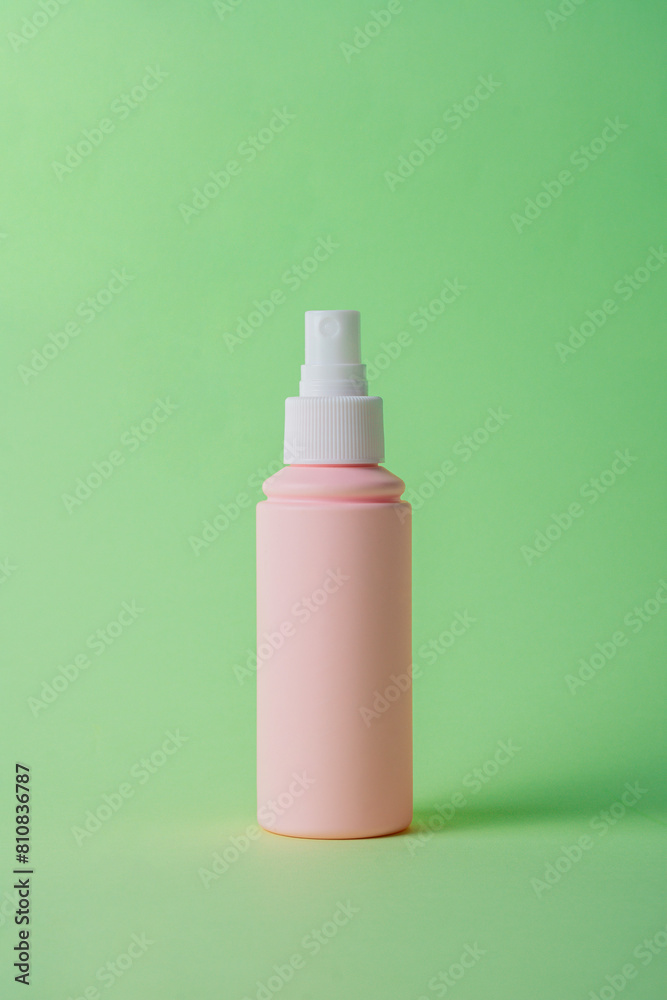 Cosmetic pink bottle, bottle, lotion or serum on green background. Cosmetic pink bottle, bottle, lotion or serum on green background.