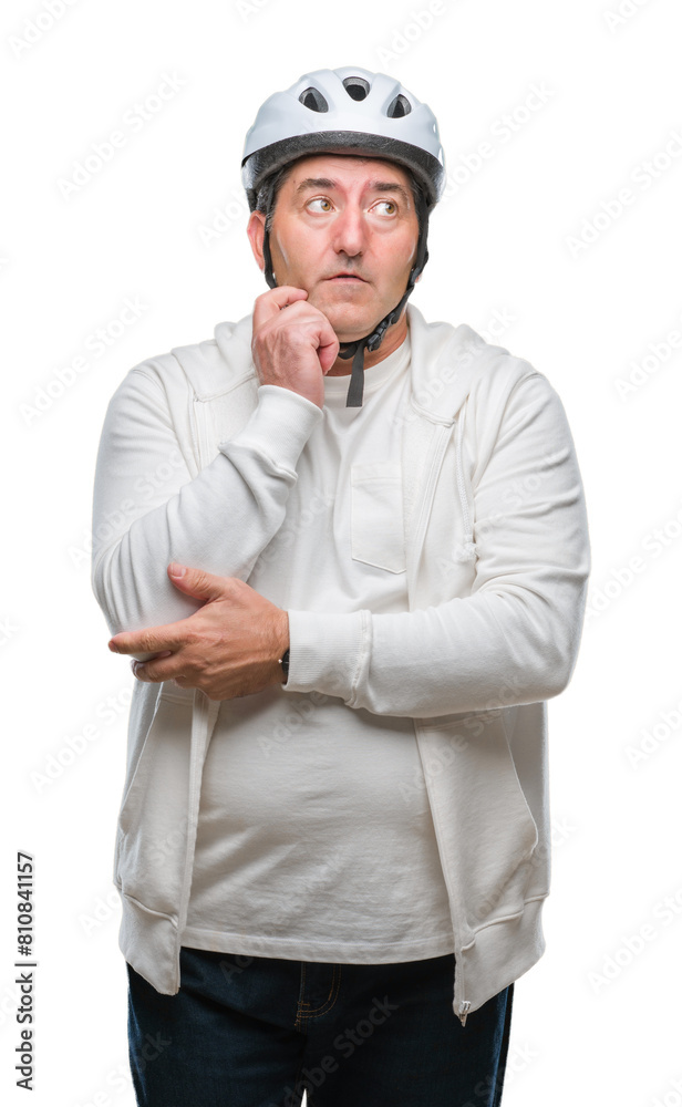 Handsome senior cyclist man wearing bike helmet over isolated background serious face thinking about question, very confused idea Handsome senior cyclist man wearing bike helmet over isolated background serious face thinking about question, very confused idea