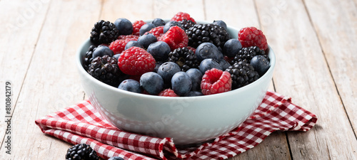 Fresh assortment berries on wooden table. Panorama view photo