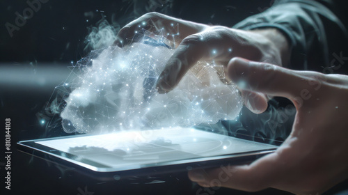 A person is touching a tablet with a cloud on it