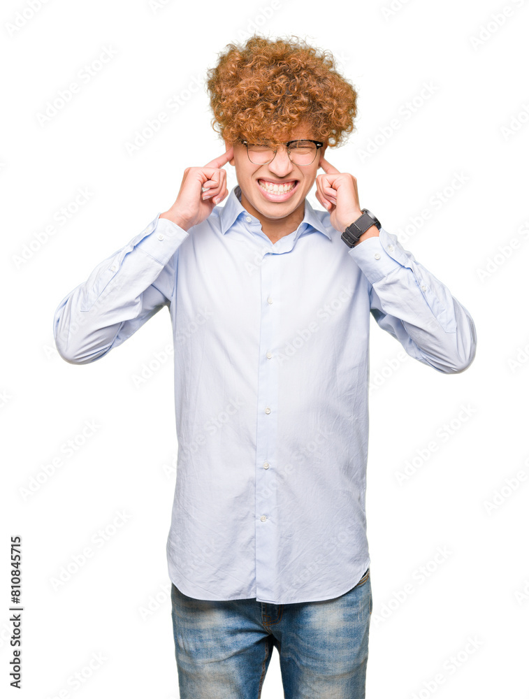 Young handsome business man with afro wearing glasses covering ears with fingers with annoyed expression for the noise of loud music. Deaf concept. Young handsome business man with afro wearing glasses covering ears with fingers with annoyed expression for the noise of loud music. Deaf concept.