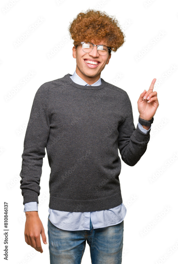 Young handsome business man with afro hair wearing glasses with a big smile on face, pointing with hand and finger to the side looking at the camera. Young handsome business man with afro hair wearing glasses with a big smile on face, pointing with hand and finger to the side looking at the camera.