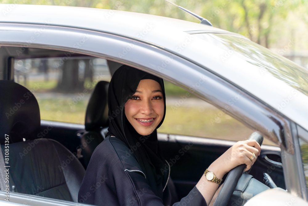 Closeup a beautiful Muslim woman in Abaya niqab traditional clothes driving a car in city Closeup a beautiful Muslim woman in Abaya niqab traditional clothes driving a car in city