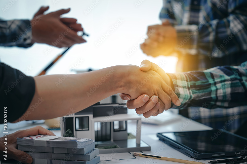 Engineers shaking hands, teamwork in meetings, drawing blueprints for condo, apartment, and house construction. Negotiating costs with contractors, bidding, and cooperating on construction sites. Engineers shaking hands, teamwork in meetings, drawing blueprints for condo, apartment, and house construction. Negotiating costs with contractors, bidding, and cooperating on construction sites.