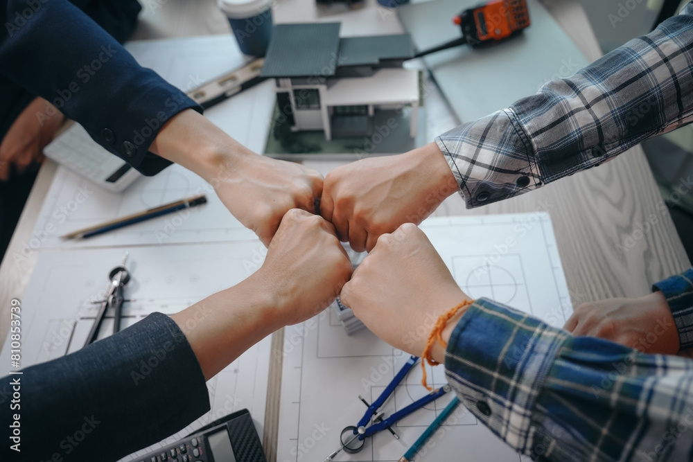 Skilled team of engineers collaborates in meetings, drafting blueprints for condos, apartments, houses. Negotiating costs, bids, and contracts, they ensure efficient cooperation on construction sites.
