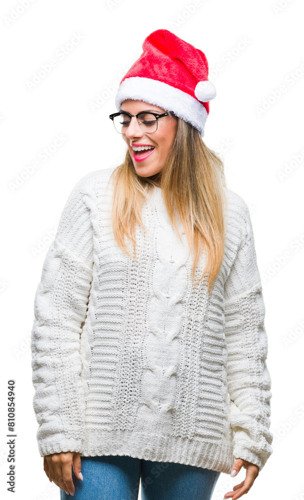 Young beautiful woman wearing christmas hat over isolated background looking away to side with smile on face, natural expression. Laughing confident. Young beautiful woman wearing christmas hat over isolated background looking away to side with smile on face, natural expression. Laughing confident.