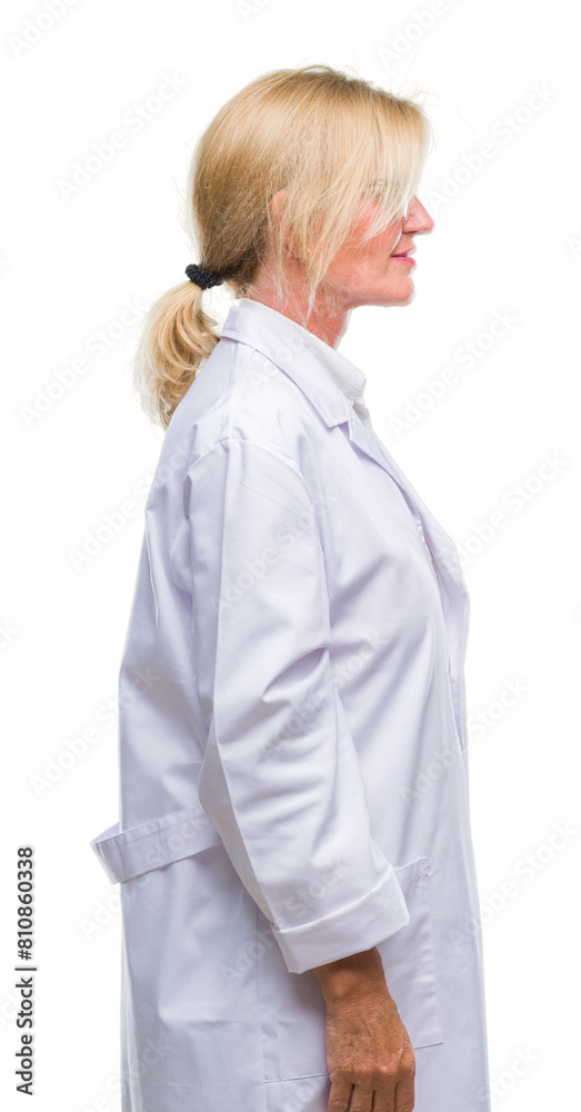 Middle age blonde therapist woman wearing white coat over isolated background looking to side, relax profile pose with natural face with confident smile.
