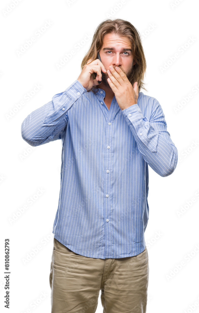 Young handsome man with long hair over isolated background talking on the phone cover mouth with hand shocked with shame for mistake, expression of fear, scared in silence, secret concept Young handsome man with long hair over isolated background talking on the phone cover mouth with hand shocked with shame for mistake, expression of fear, scared in silence, secret concept