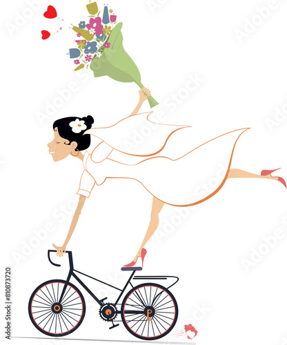 Happy bride riding a bike and holding a bunch of flowers. Pretty bride in the white dress and wedding veil riding a bike with a bunch of flowers. Isolated on white background