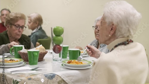 Senior women eating food during dinner in retirement home