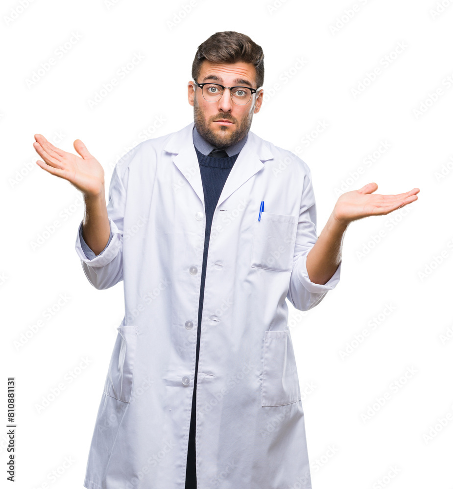 Young handsome man wearing doctor, scientis coat over isolated background clueless and confused expression with arms and hands raised. Doubt concept. Young handsome man wearing doctor, scientis coat over isolated background clueless and confused expression with arms and hands raised. Doubt concept.