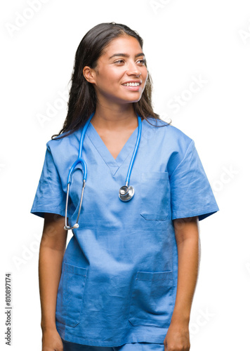 Young arab doctor surgeon woman over isolated background looking away to side with smile on face, natural expression. Laughing confident.