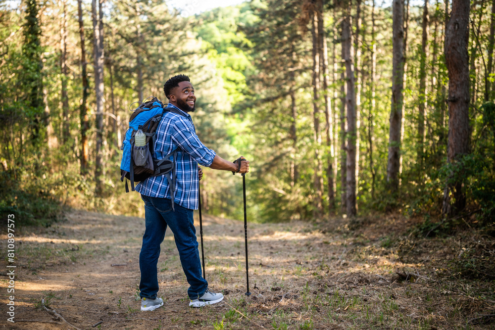 Young man enjoys hiking in nature. Young man enjoys hiking in nature.